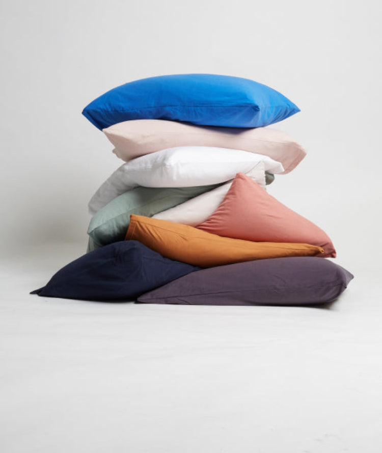 It-fits jersey pillow slips in Royal blue, pink, white, sage green, beige, rose, ginger brown, navy blue and charcoal grey  ascetically stacked