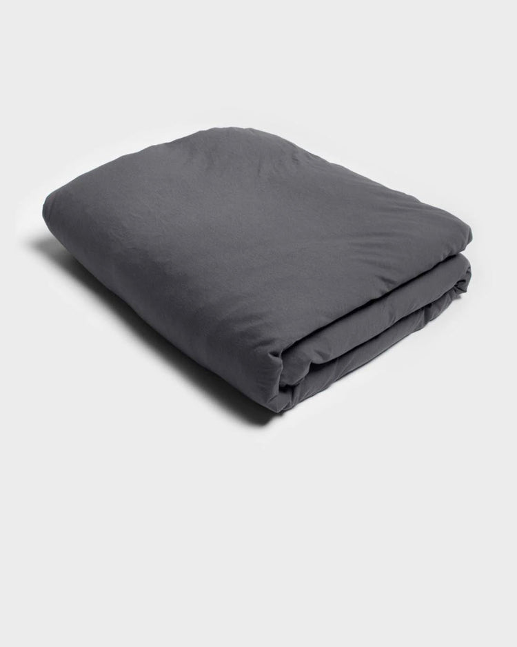 soft jersey quilt cover by It-fits in charcoal grey displayed on a neatly folded doona on a plain background