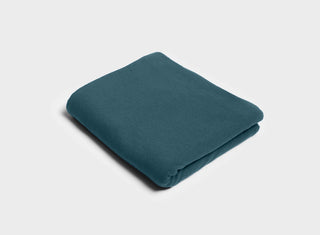 Petrol green flat sheet by It-Fits, folded neatly, made from smooth, breathable 100% Australian cotton jersey for summer comfort.