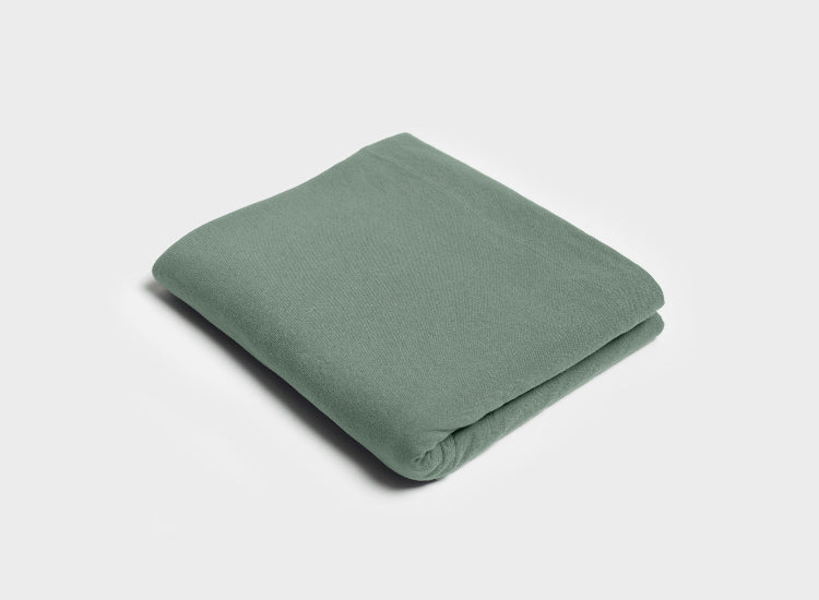 Sage green flat sheet by It-Fits featuring a wide top edge, crafted from breathable 100% Australian cotton jersey and neatly folded