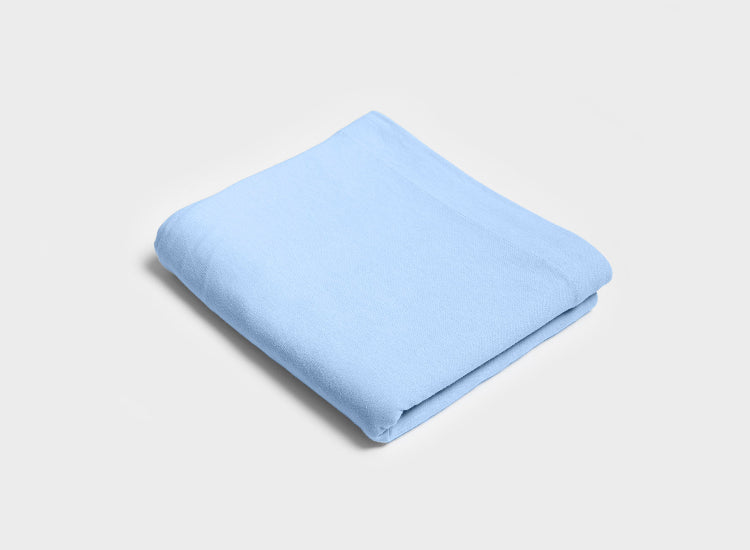 Sky blue folded top sheet by It-Fits, featuring a wide top edge, crafted from soft, breathable 100% Australian cotton jersey.