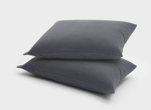 It-Fits cooling jersey pillow slips, 2 pack on stacked pillows, crafted from soft, breathable 100% Australian cotton, indicating a cozy, temperature-regulating sleep experience.