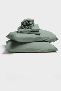 Sage Green Colour jersey sheet set by It-fits, displayed as a stack with 2 pillows with pillow cases at the bottom followed by a flat sheet and a rolled fitted sheet on top